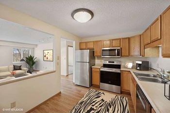 A kitchen with wooden cabinets and stainless steel appliances.